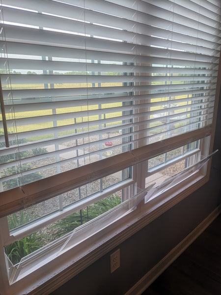 House window rain guard by Invisible Awning. Keep rain out while allowing fresh air in.