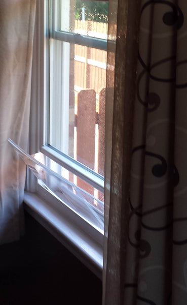 House window rain guard by Invisible Awning. Keep rain out while allowing fresh air in.